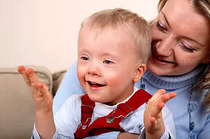 a woman is holding a small child on her lap.