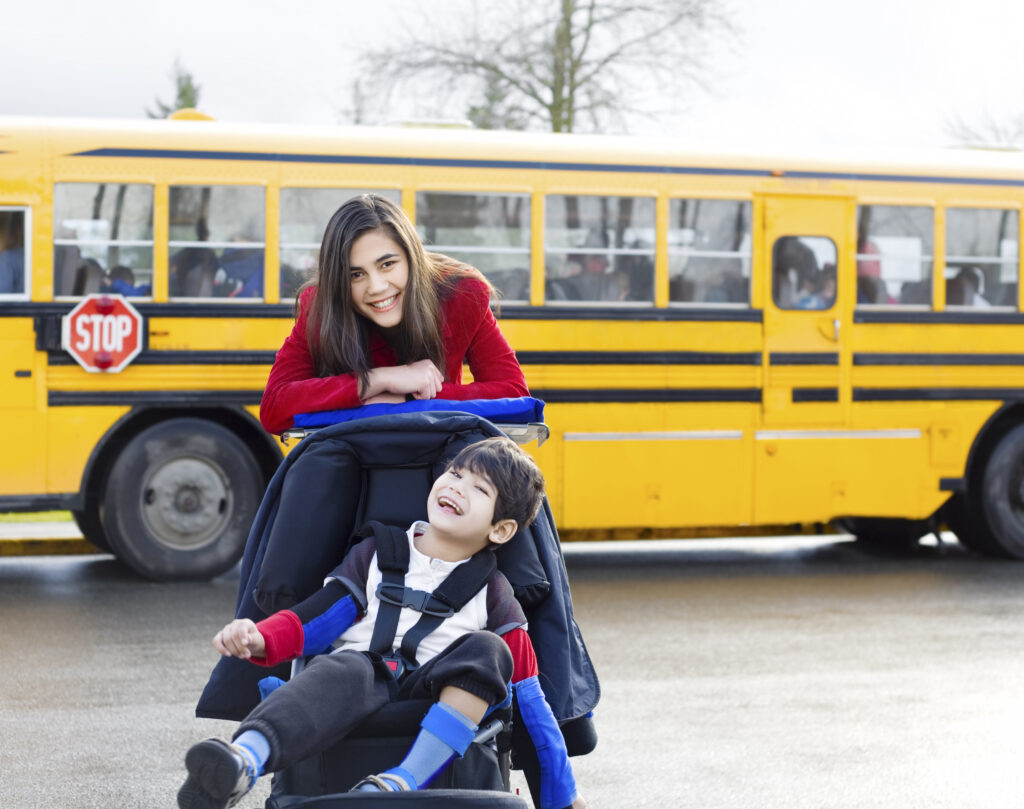 A young child riding on the back of a school bus