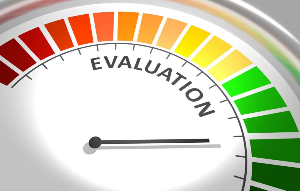Circular evaluation gauge labeled EVALUATION with a red-to-green color gradient and a needle pointing to mid-range.