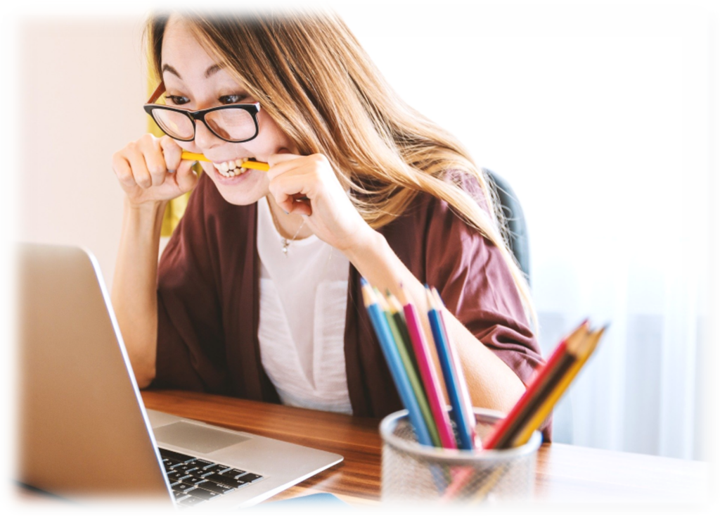 A woman sitting at a table using a laptop